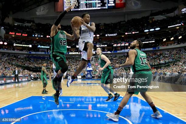 Yogi Ferrell of the Dallas Mavericks passes the ball against Al Horford of the Boston Celtics and James Young of the Boston Celtics in the second...