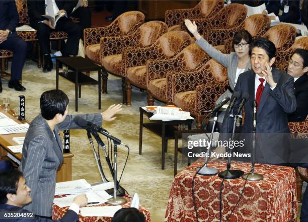 Japanese Prime Minister Shinzo Abe interrupts Democratic Party lawmaker Kiyomi Tsujimoto as she directs a question to Defense Minister Tomomi Inada...