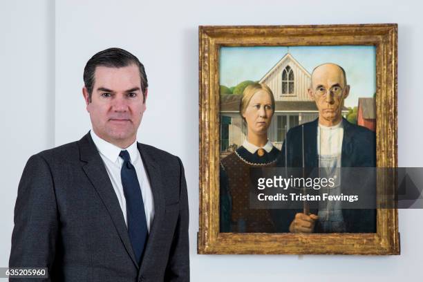 James Rondeau, Director of the Art Institute of Chicago stands next to the iconic painting American Gothic, 1930 by Grant Wood, as it is installed at...