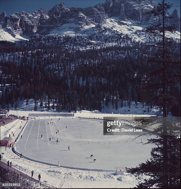 Speed skaters on an outdoor ice rink at the 1956 Winter Olympic Games at Cortina, Italy. | Location: Cortina, Italy.