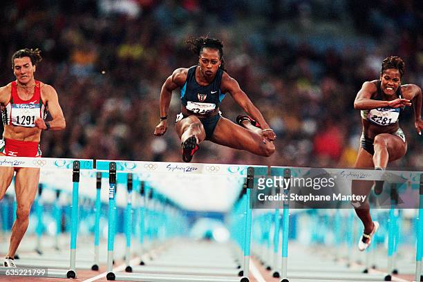 Gail Devers of the USA glides over a hurdle in the women's 100-meter hurdles during the Sydney 2000 Olympics.