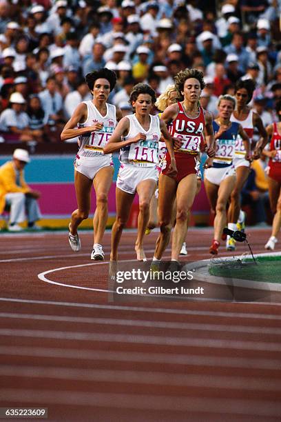 Barefoot runner from Great Britain Zola Budd, jersey 151, and Mary Decker from the US during the women's 3000-meter race of the 1984 Olympics.