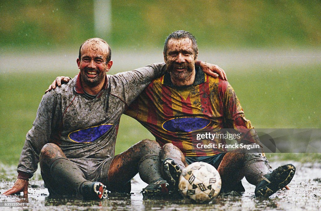 Soccer Players Sitting in Mud