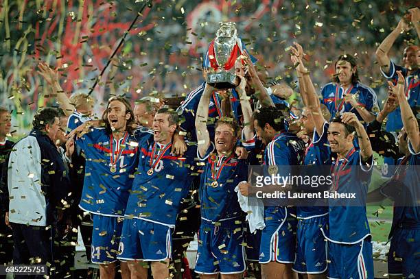 French captain Didier Deschamps lifts the trophy amidst his teammates after France wins the 2000 UEFA European Championship final, France vs Italy .