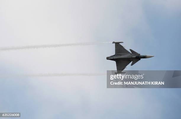 Saab JAS 39 Gripen performs during an aerial display over Yelahanka Air Force Station on the inaugural day of the 11th edition of 'Aero India', a...