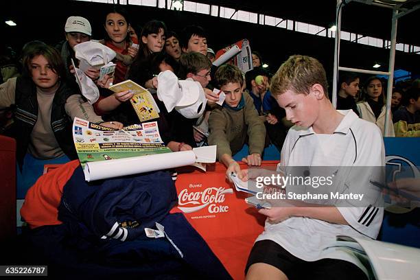 Andy Murray from Great Britain signs autographs during the 2001 Les Petits As Tournament.