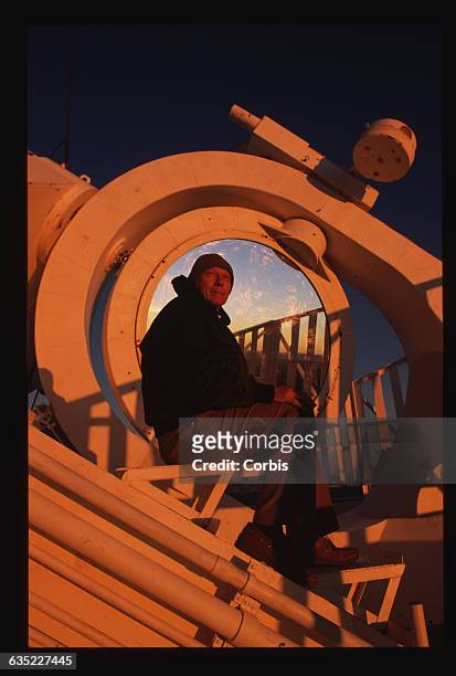 Keith Pierce sits by the heliostat on the McMath-Pierce Solar Telescope.
