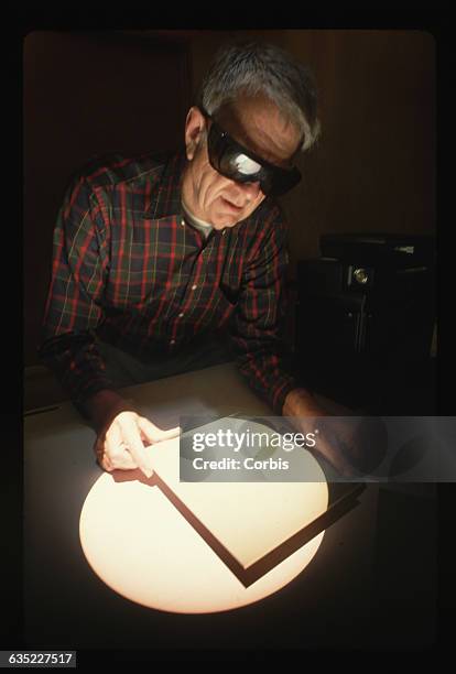 Astronomer Bill Livingston looks at an image of the sun, deep within the McMath Pierce Solar Telescope at Kitt Peak National Observatory.