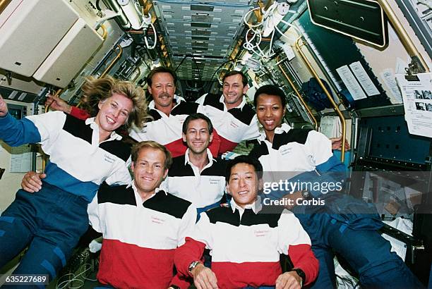 The crew of the shuttle Endeavor on STS-47. Jay Apt is center. Clockwise from right is Dr. Mae Jemison, Mamoru Mohri of Japan, Mark Lee, and his wife...