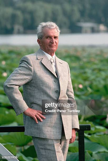 Romanian dictator Nicolae Ceausescu poses beside a pond blooming with water lilies at his villa near Bucharest in August 1989. | Location: Near...