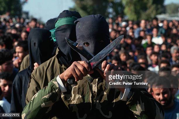 Masked members of the extremist group Hamas, called Azzediwi warriors, take part in a demonstration protesting the Israeli-Palestinian peace accord...