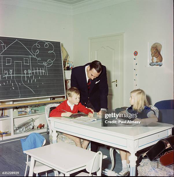 Luxembourg's Grand Duke Jean looks over his children's schoolwork, 1966. Princess Marie Astrid is the Duke's eldest child, Prince Henri, the eldest...