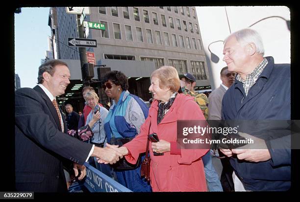 New York, New York: Picture shows New York Governor, George Pataki, shaking hands with people in the street.