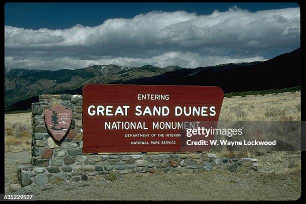 Sign for Great Sand Dunes National Monument which is both in Colorado and New Mexico. 1989.