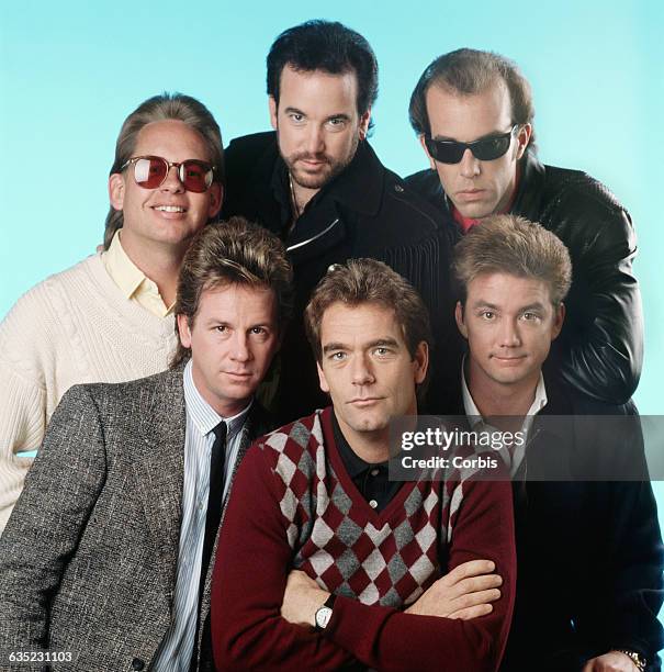 Huey Lewis and his bandmates Mario Cipollina, Johnny Colla, Bill Gibson, Chris Hayes, and Sean Hopper pose together.