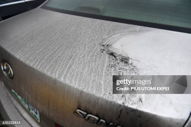 Black soot covers a car parked in the city of Port Harcourt, Rivers State, on February 14, 2017. The Nigerian city of Port Harcourt used to be known...