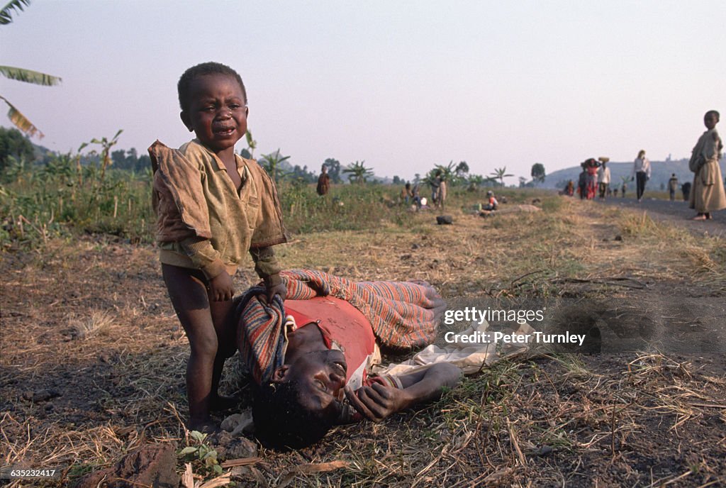 Boy Crying over His Dead Father's Body