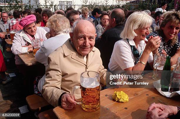 Table of happy Germans enjoys the Oktoberfest experience.