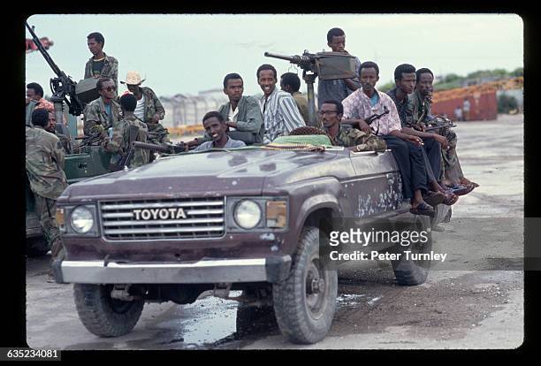 Militamen, part of a factional group fighting in the civil war, gather in a Toyota "technical car" just prior to the arrival of U.S. And...