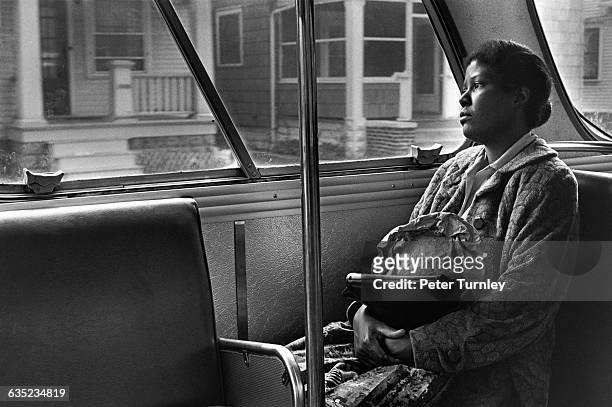 Woman who works as a cleaning lady rides the bus home in Fort Wayne, Indiana.