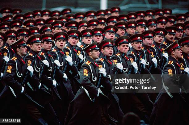 Soviet military men march in formation during a parade commemorating the 73rd anniversary of the Russian Revolution.