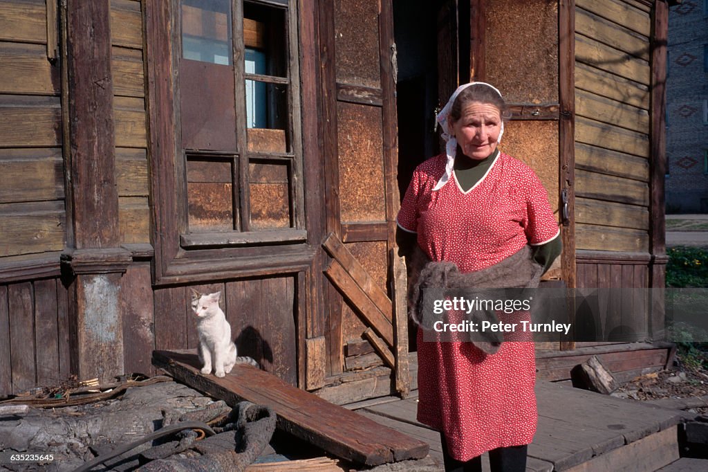 Woman Standing Outside Her House
