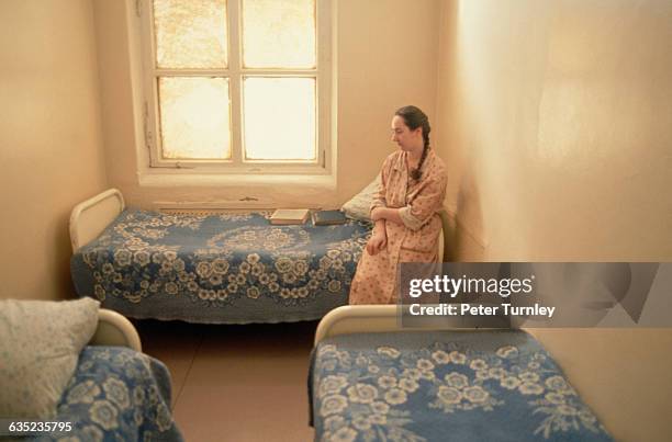 Mentally-ill patient stands alone in her room at the Serbsky National Research Center for Social and Forensic Psychiatry.