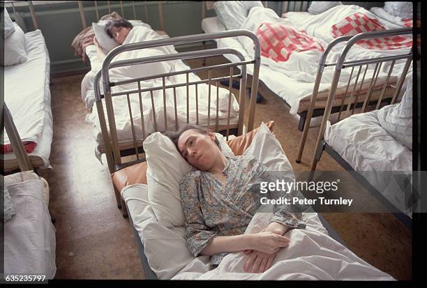 Mentally-ill patients rest in their beds at the Gilyarovsky Psychiatric Clinic.