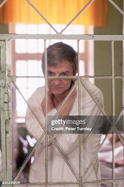 Mental Patient Behind Cell Bars