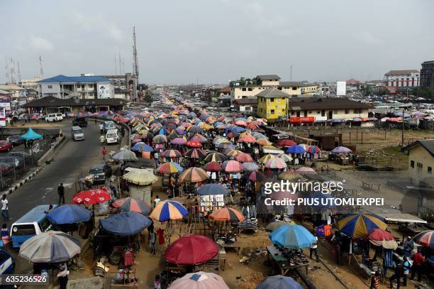 Traders cover their wares with umbrellas of different shapes and sizes along the railway line in Port Harcourt city, Rivers State, on February 14,...