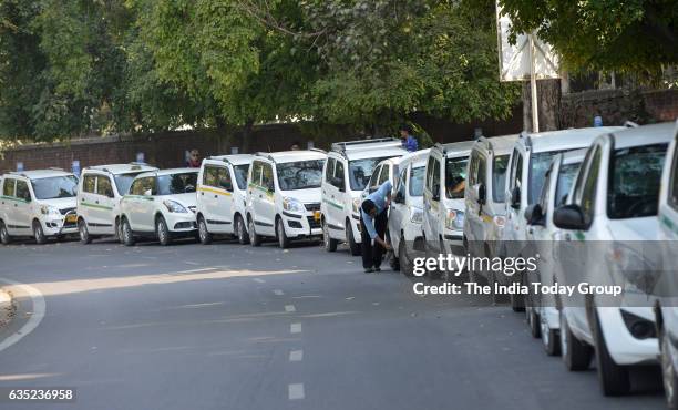 Ola and Uber taxi driver cleaning the car during the fourth day of their strike against withdrawal of incentives by the app-based cab aggregators, at...