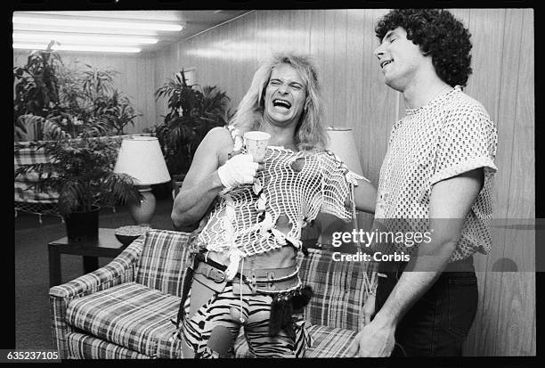 Singer David Lee Roth hangs out with MTV Veejay Mark Goodman in his dressing room at the 1983 US Festival.