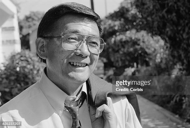 Congressman Norman Mineta stands in front of the home from which he was evacuated in 1942 during the evacuation and internment of Japanese Americans...