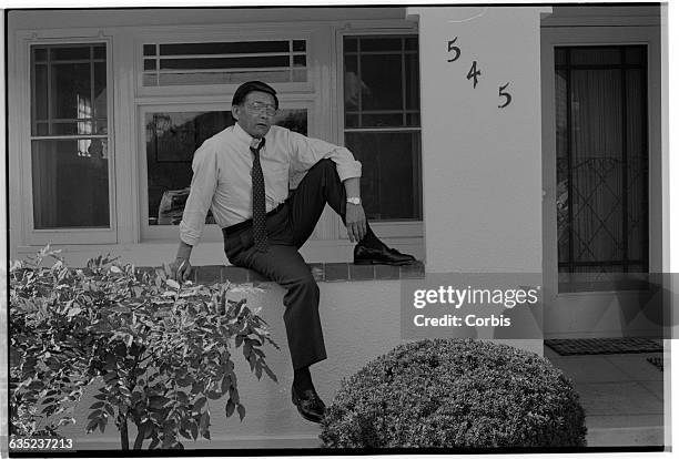 Congressman Norman Mineta poses in front of the home from which he was evacuated in 1942 during the evacuation and internment of Japanese Americans...