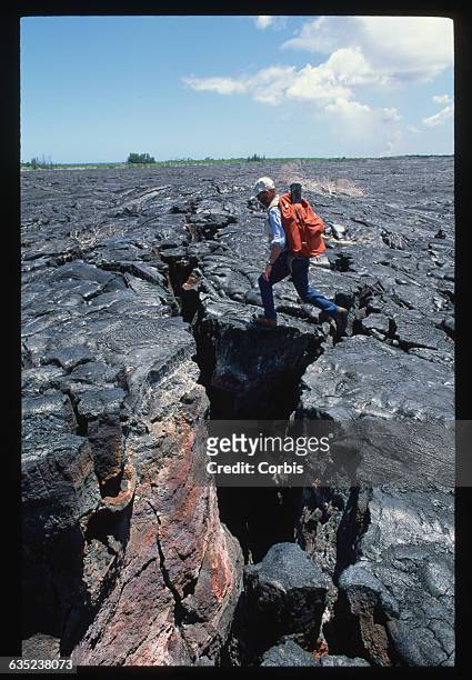 James Moulds walks across a dried out lava flow to reach is buried property in the Kalapana village of Hawaii.