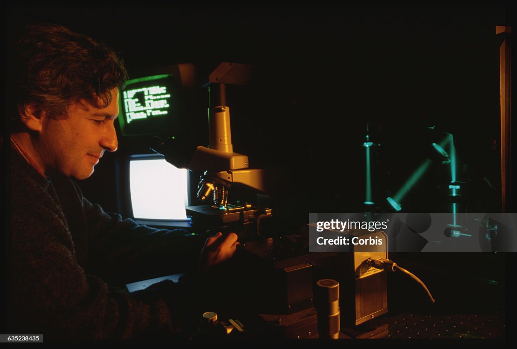 Scientist With Laser Microscope