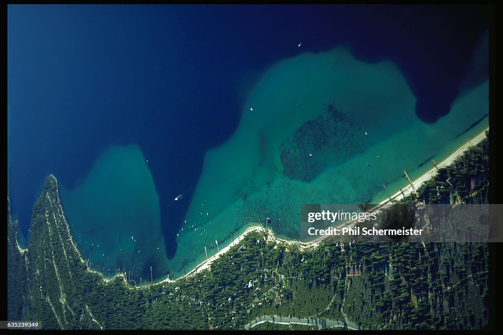 An aerial view of the Lake Tahoe shoreline. Roads and buildings line