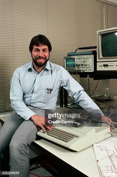 Steve Wozniak, designer of the Apple II, sits with one of the machines, which was the most successful personal computer of its day.