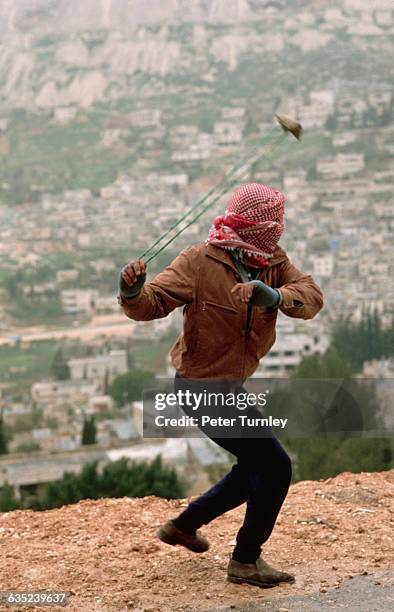 Palestinian Slinging a Rock