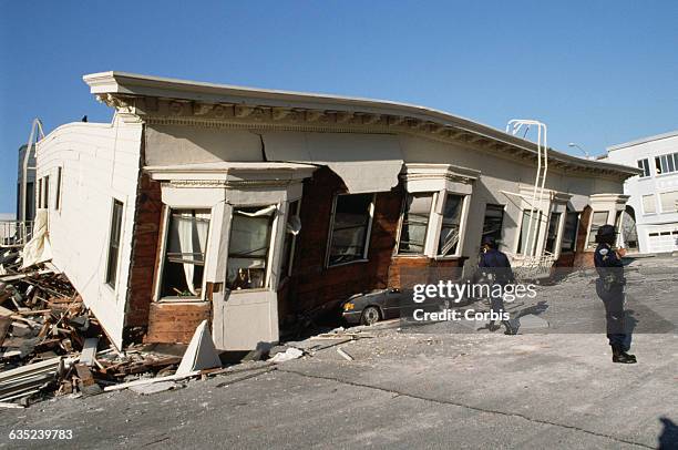 Marina District apartment building that was heavily damaged in the 1989 San Francisco earthquake. Police officers patrol the neighborhood to prevent...