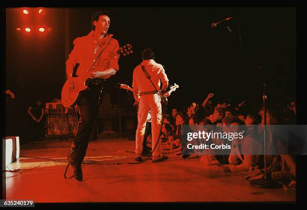 Mick Jones and Joe Strummer play guitar in concert on the first night of The Clash's 1979 American tour.