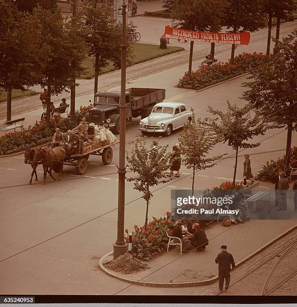 Horsecart mixes with traffic on the Avenue of the Red Army in Debrecen, Hungary.