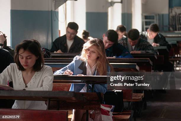 High school students take a test in philosophy class at a local polytechnical university. Their Siberian town is suffering widespread economic...