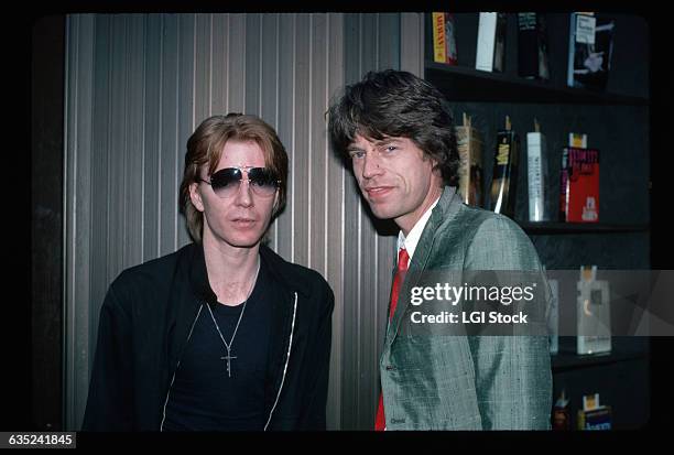 Writer and musician Jim Carroll stands with Rolling Stones singer Mick Jagger.
