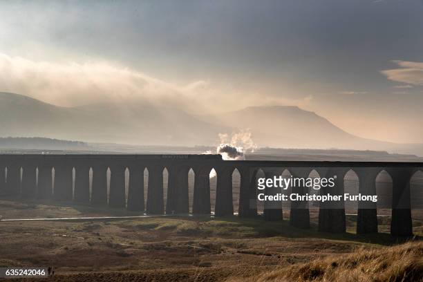 The Tornado steam locomotive pulls the first timetabled main line steam-hauled service for half a century across the Ribblehead viaduct in North...
