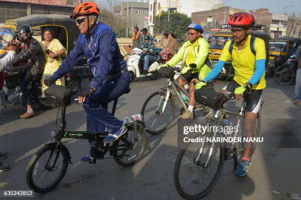 Indian cyclists Jugal Kishore Rajesh Sharma and Raj Mhatre ride along a road in Amritsar on February 14 during their journey from the India-Pakistan...