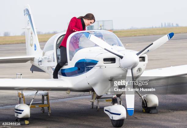 Catherine, Duchess of Cambridge climbs onto an aircraft during a visit to the RAF Air Cadets at RAF Wittering on February 14, 2017 in Stamford,...