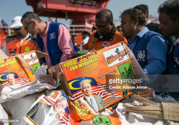 Staff converses with Nautical Aliya crew as they sort aid given from the Nautical Aliya February 14, 2017 in Chittagong, Bangladesh. The Rohingya aid...