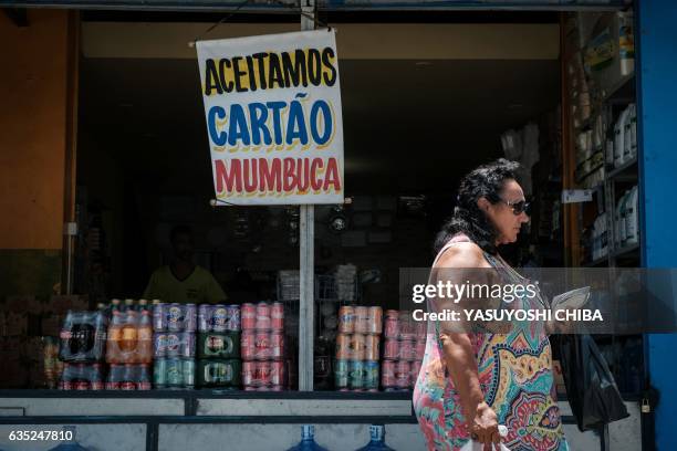 Store shows a placard reading "Mumbuca card accepted" in Marica, surburb of Rio de Janeiro, Brazil, on February 8, 2017. Mumbuca, the first virtual...