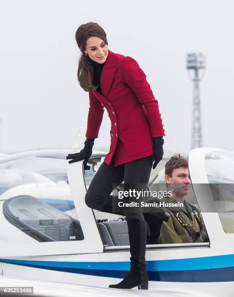Catherine, Duchess of Cambridge climbs off an aircraft during a visit to the RAF Air Cadets at RAF Wittering on February 14, 2017 in Stamford,...